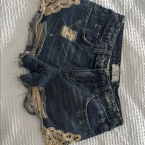 Free People Distressed Denim Shorts with Lace Accents